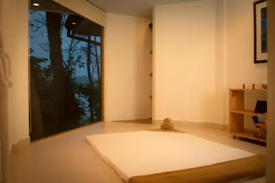 a room with a teddy bear sitting next to a window at Arenas Del Mar Beachfront & Rainforest Resort Member of the Cayuga Collection in Manuel Antonio