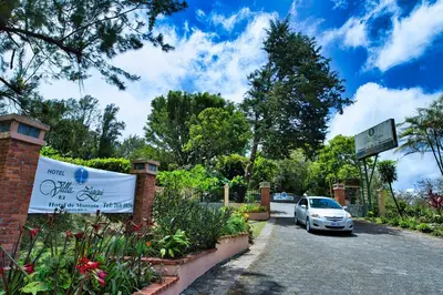 a car parked in a parking lot with a sign at Hotel Villa Zurqui in San José