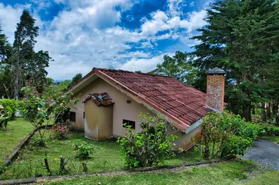 a small house with a red roof at Hotel Villa Zurqui in San José