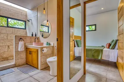 a bathroom with a toilet and a shower and a sink at Hotel Villas Tangerine in Sámara
