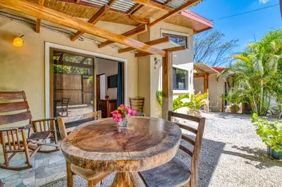 a wooden table and chairs on a patio at Hotel Villas Tangerine in Sámara