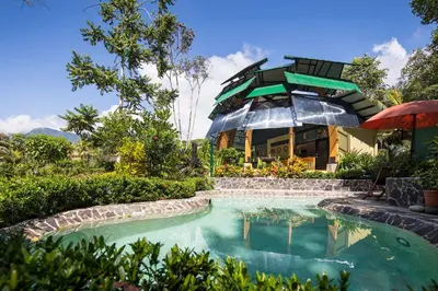 a house with a swimming pool in front of a building at Yaba Chigui Lodge in Ojochal