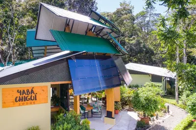 a building with blue balconies and a restaurant at Yaba Chigui Lodge in Ojochal