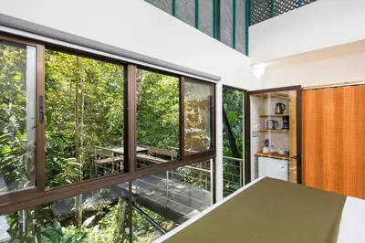 a house in the woods with large windows at Yaba Chigui Lodge in Ojochal