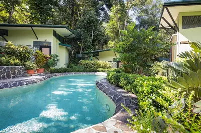 a swimming pool in front of a house at Yaba Chigui Lodge in Ojochal