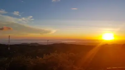 a sunset with the sun setting over the mountains at Chira Glamping Resort Monteverde in Monteverde Costa Rica