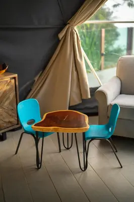 a living room with a table and two chairs at Chira Glamping Resort Monteverde in Monteverde Costa Rica
