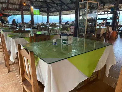 a table in a restaurant with white and green at Valle Encantado in San Isidro