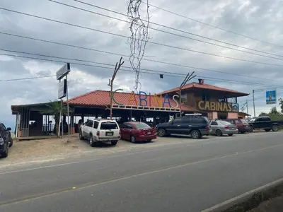 a building with cars parked on the side of a street at Valle Encantado in San Isidro