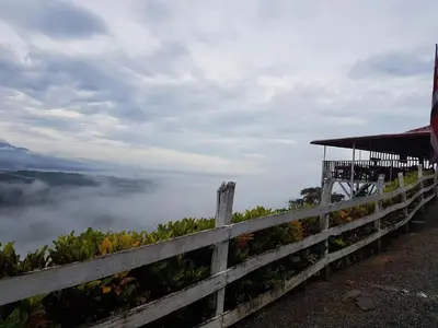 a fence on top of a mountain with fog in the background at Valle Encantado in San Isidro