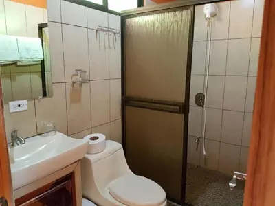 a bathroom with a shower and a toilet and a sink at Valle Encantado in San Isidro