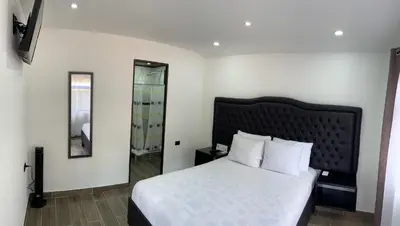 a bedroom with a bed and a mirror at Cabinas Vista Al Golffo in Monteverde Costa Rica