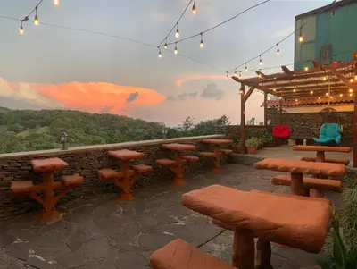 a group of wooden benches and tables on a patio at Cabinas Vista Al Golffo in Monteverde Costa Rica