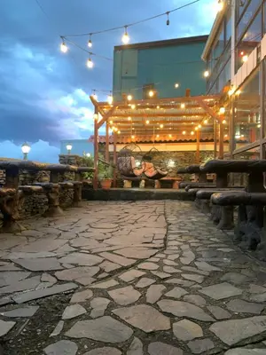 a patio with lights and benches in front of a building at Cabinas Vista Al Golffo in Monteverde Costa Rica