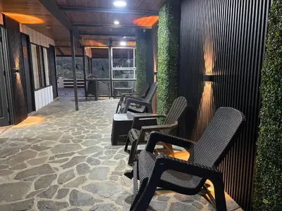 a row of chairs sitting on a patio at Cabinas Vista Al Golffo in Monteverde Costa Rica