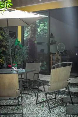 two chairs and a table with an umbrella at Blanconejo de Montezuma in Montezuma