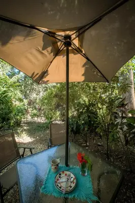 a table with a plate and an umbrella at Blanconejo de Montezuma in Montezuma