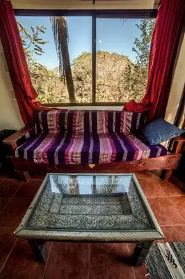 a couch in a room with a large window at Blanconejo de Montezuma in Montezuma