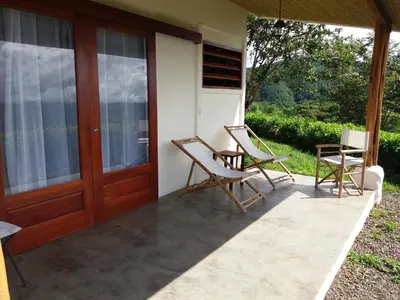 two chairs sitting on the porch of a house at Hotel Peace & Lodge in Sámara