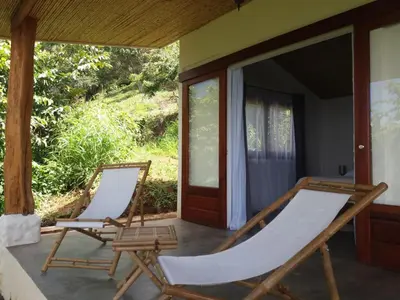 two chairs on the porch of a house at Hotel Peace & Lodge in Sámara