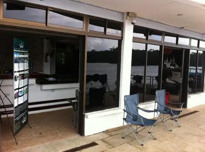 a group of chairs sitting outside of a building at Tortuguero Adventures GuestHouse in Tortuguero