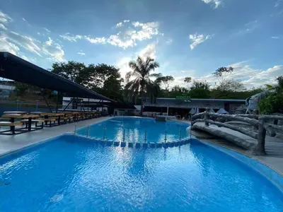 a large swimming pool with blue water in a resort at Hotel PZ Country Club & Conference Center in San Isidro