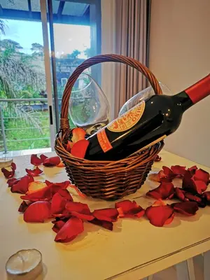 a basket of wine and roses on a table at Hotel PZ Country Club & Conference Center in San Isidro