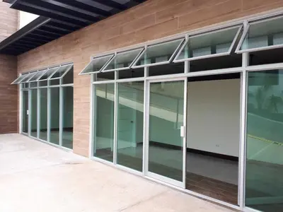 a building with glass doors on the side of it at Hotel PZ Country Club & Conference Center in San Isidro