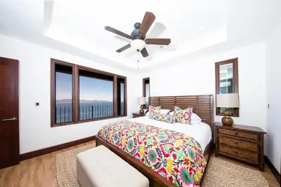a bedroom with a bed and a ceiling fan at 360 Splendor Del Pacifico Residences in Playa Flamingo