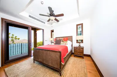 a bedroom with a bed and a large window at 360 Splendor Del Pacifico Residences in Playa Flamingo