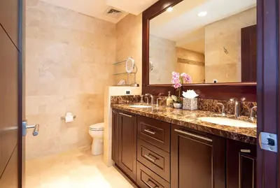 a bathroom with a sink and a toilet and a mirror at 360 Splendor Del Pacifico Residences in Playa Flamingo