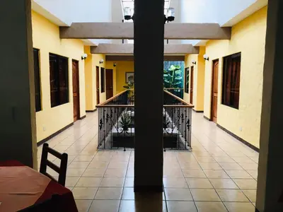 a room with a balcony with a table and chairs at Hotel Casa Esmeralda in Sámara