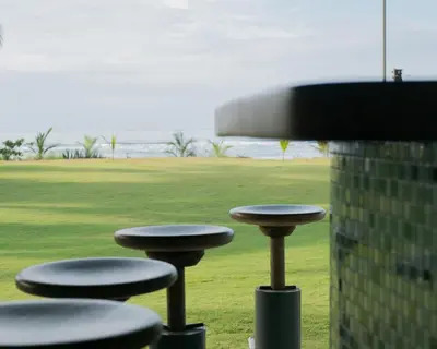 a group of stools in front of a field at Totobe Resort in Jabilla