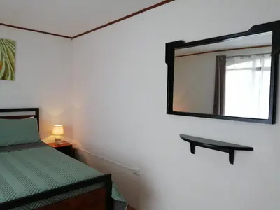 a bedroom with a bed and a mirror on the wall at Hotel Santa Fe B&B in Monteverde Costa Rica