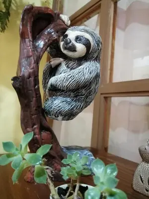 a statue of a sloth hanging from a tree at Hotel Santa Fe B&B in Monteverde Costa Rica