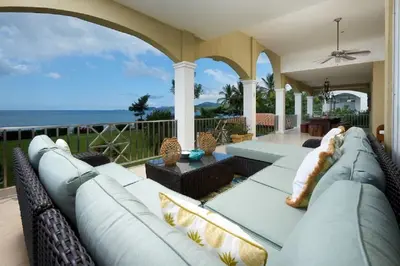 a living room with a couch and a view of the ocean at Beachfront Potrero - nice 7-BR villa, private cook included - Casa Royal in Potrero