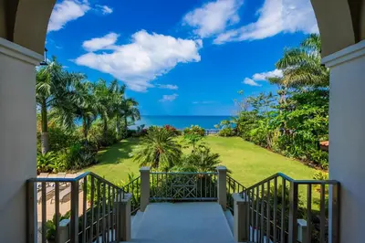 a staircase leading to a house with a view of the ocean at Beachfront Potrero - nice 7-BR villa, private cook included - Casa Royal in Potrero