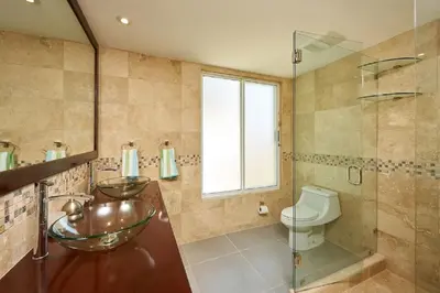 a bathroom with two sinks and a toilet at Beachfront Potrero - nice 7-BR villa, private cook included - Casa Royal in Potrero