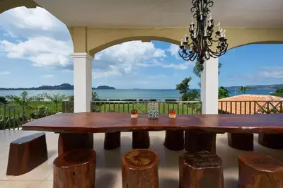 a dining room table with a view of the ocean at Beachfront Potrero - nice 7-BR villa, private cook included - Casa Royal in Potrero