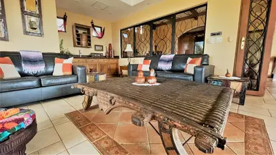 a living room with a couch and a table at Playa Potrero, Oceanview Villa Oasis with salt-water pool for up to 8 people in Potrero