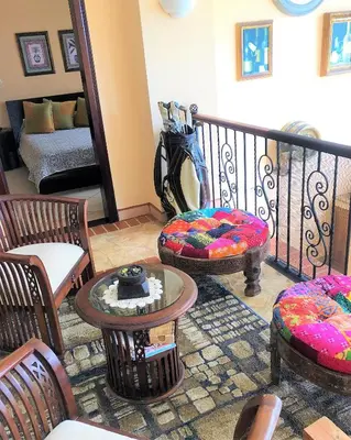a living room with chairs and tables and a couch at Playa Potrero, Oceanview Villa Oasis with salt-water pool for up to 8 people in Potrero