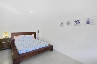 a bedroom with a bed and a white wall at Playa Potrero - beachfront Villa, big private pool - Casa Bella Catalina in Potrero