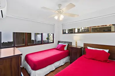 a bedroom with two beds and a ceiling fan at Playa Potrero - beachfront Villa, big private pool - Casa Bella Catalina in Potrero