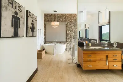 a bathroom with a tub and a large mirror at Casa Symbiotica - Exclusive Villa with Gym, Infinity Pool & Housekeeping in Brasilito