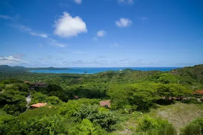 a view of the ocean from a hillside at Casa Symbiotica - Exclusive Villa with Gym, Infinity Pool & Housekeeping in Brasilito