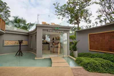 a house with a glass entryway with a woman in a store at Hotel Boutique Lagarta Lodge in Nosara