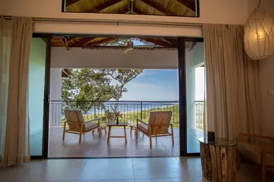 an open living room with a view of the ocean at Hotel Boutique Lagarta Lodge in Nosara