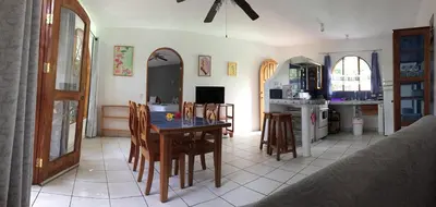 a kitchen and dining room with a table and chairs at La Perlita in Jacó