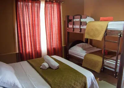 a bedroom with two bunk beds and a window at Cabañas San Isidro in Ángeles