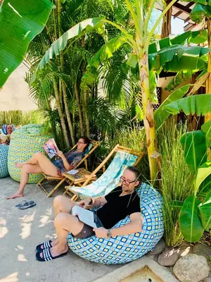 a group of people sitting in chairs on the beach at Ten North Tamarindo Beach Hotel in Tamarindo